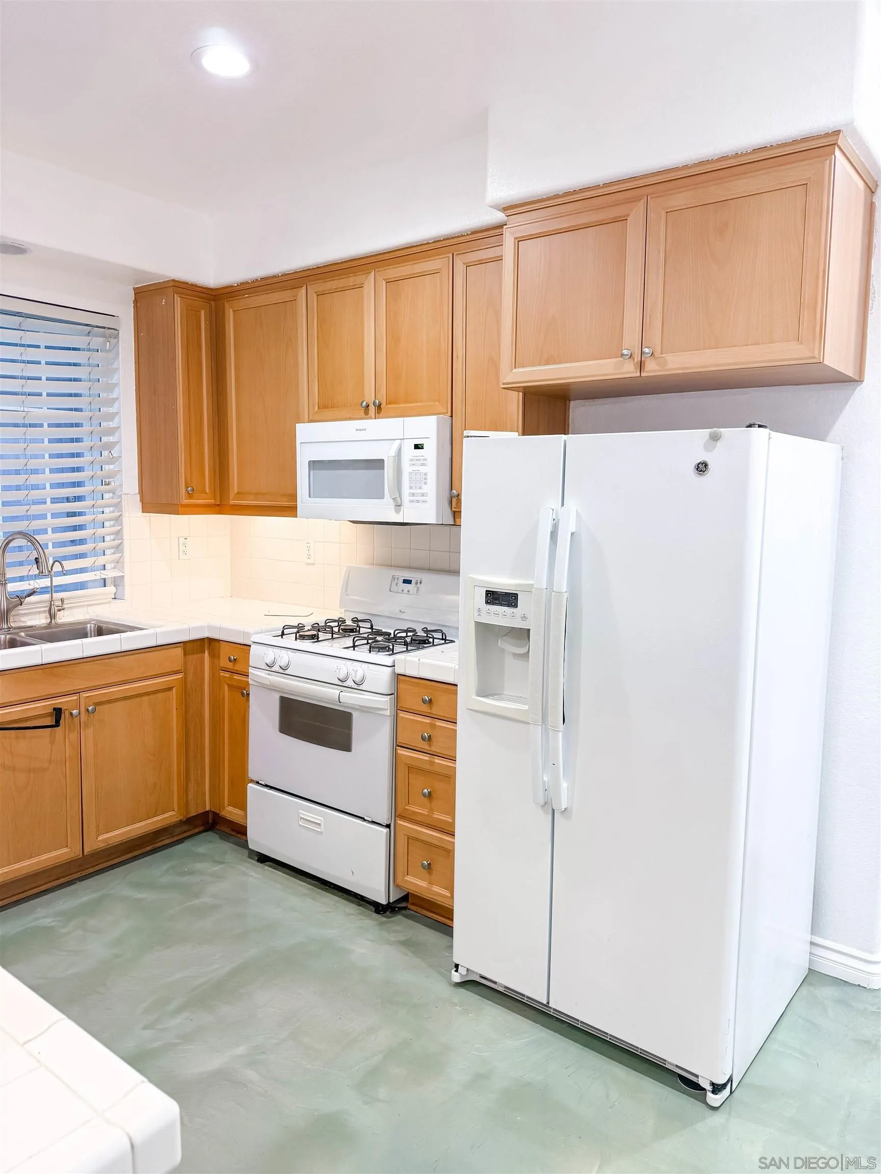 1431 Trouville Lane, Unit 5 Chula Vista, CA 91913 - Photo 9 of 28 a white refrigerator freezer sitting inside of a kitchen