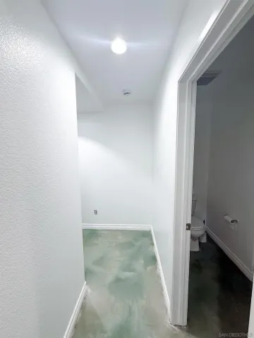 an empty room with wooden floor and window