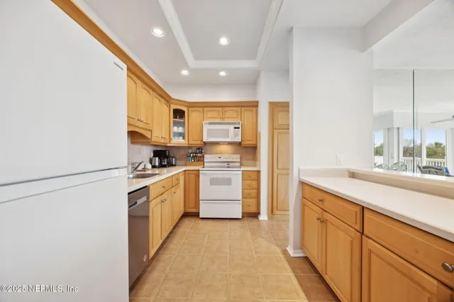 a kitchen with a sink a refrigerator and cabinets