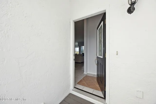 a living room with furniture a flat screen tv and kitchen view