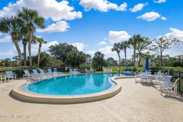 a view of a swimming pool and a yard