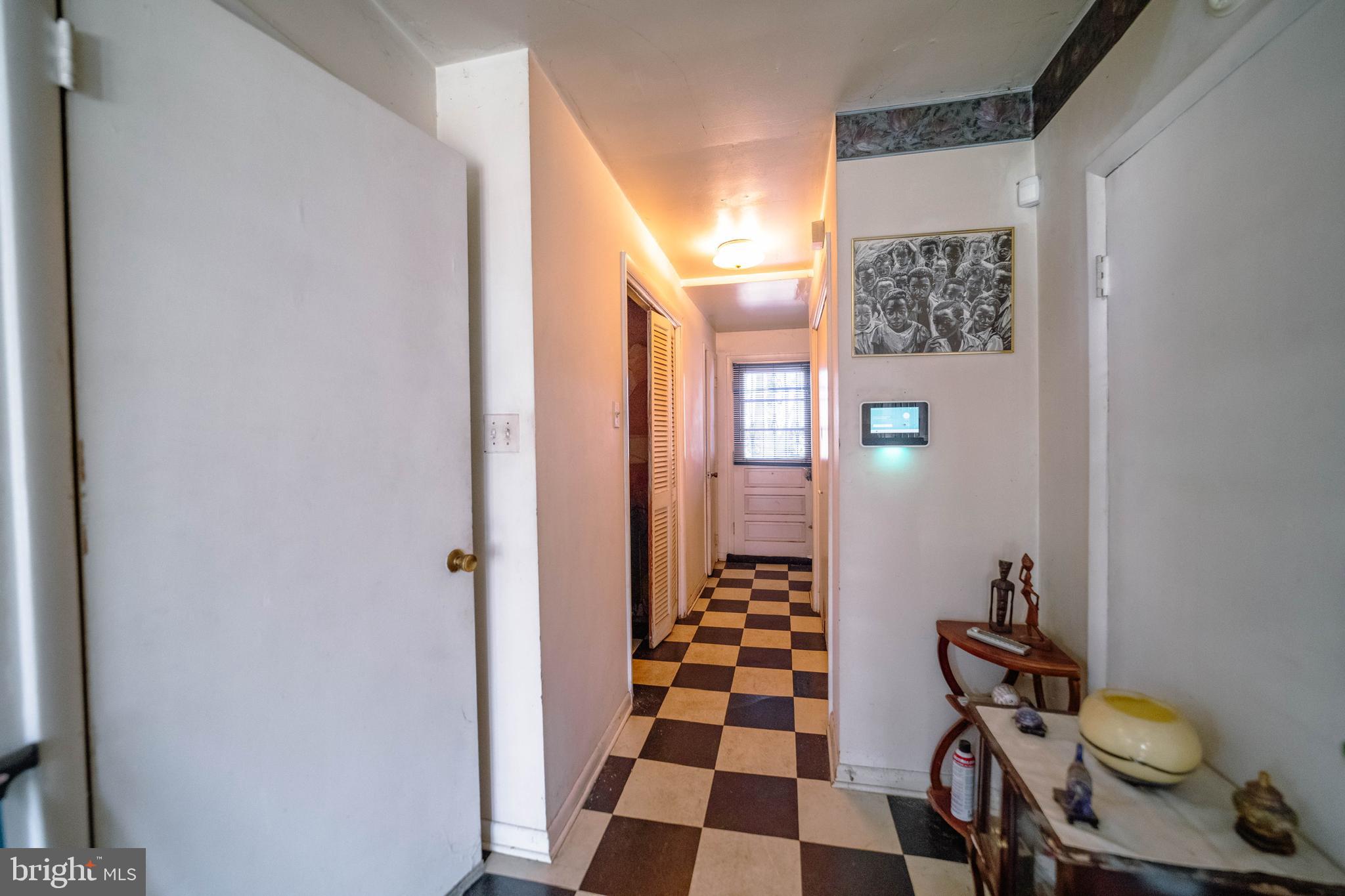 6900 Temple Hill Road Temple Hills, MD 20748 - Photo 6 of 43 a view of a hallway with wooden floor and a bathroom