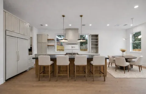 an empty room with cabinet and windows
