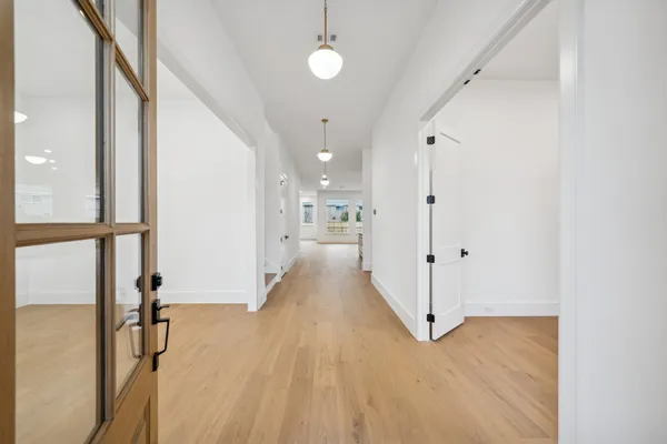 a view of a hallway with wooden floor