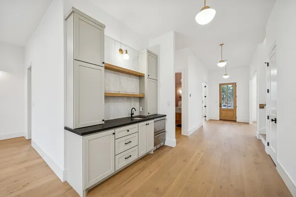 a view of an empty room with a fireplace and a window