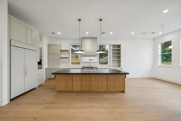 a large kitchen with stainless steel appliances kitchen island a large counter top and a sink