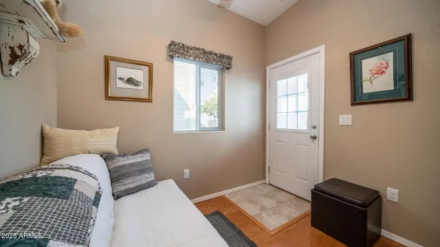 a bedroom with a bed and wooden floor