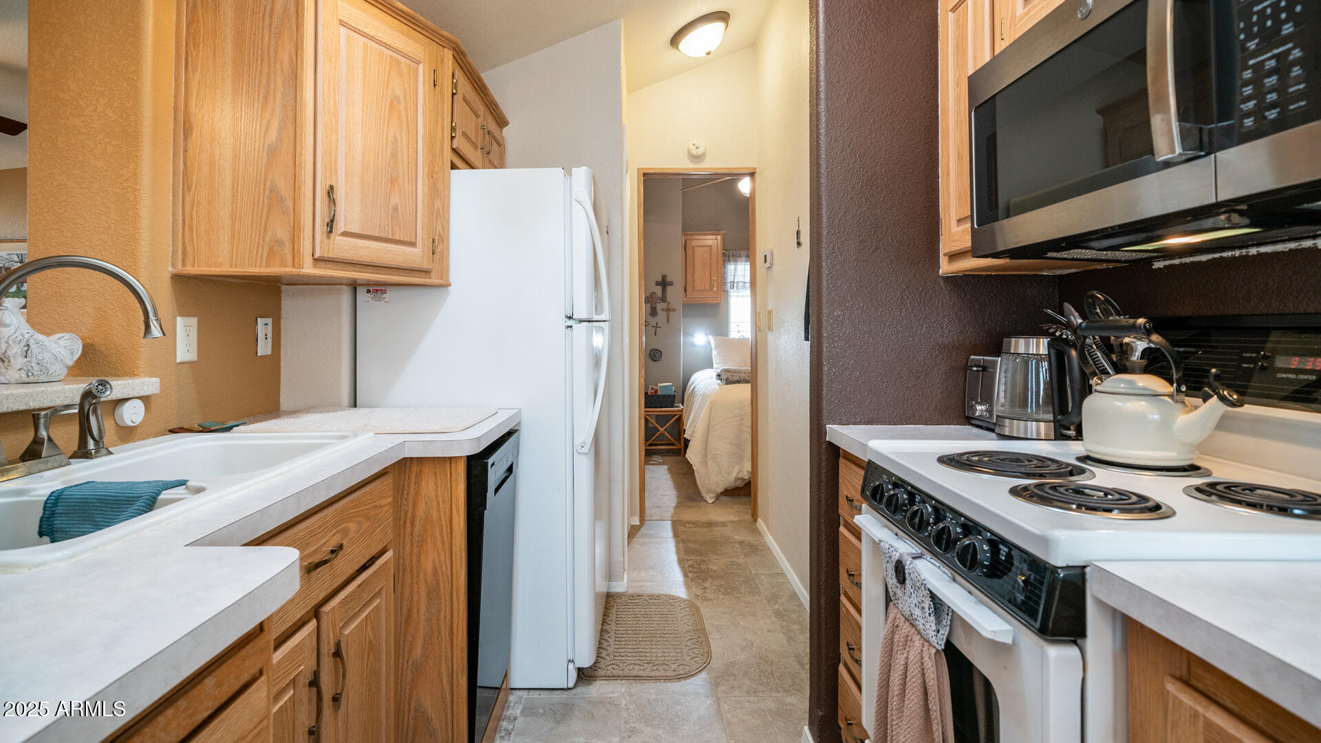 361 Felspar Drive Apache Junction, AZ 85119 - Photo 23 of 71 a kitchen with stainless steel appliances granite countertop a stove and a refrigerator