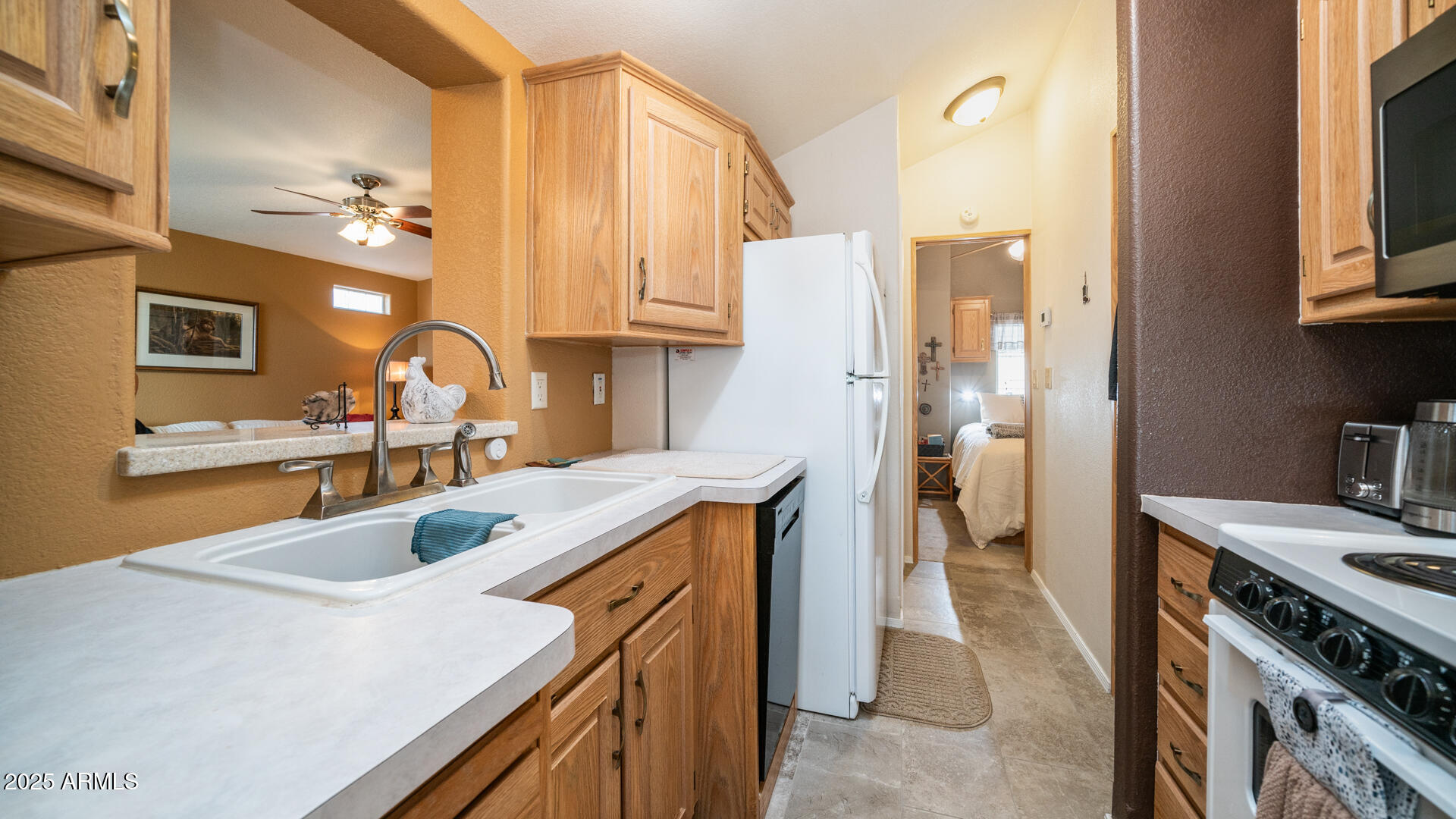 361 Felspar Drive Apache Junction, AZ 85119 - Photo 24 of 71 a kitchen with a sink stove and refrigerator