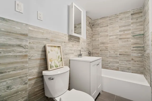 a bathroom with a sink a toilet and bathtub
