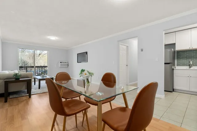 a dining room with furniture and wooden floor
