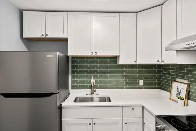 a kitchen with a sink and cabinets