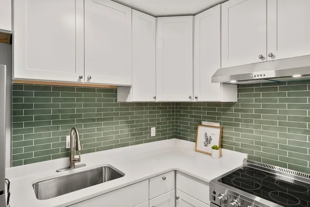 a kitchen with a sink and cabinets