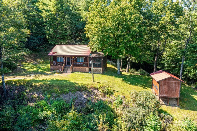 a view of a house with a yard and sitting area