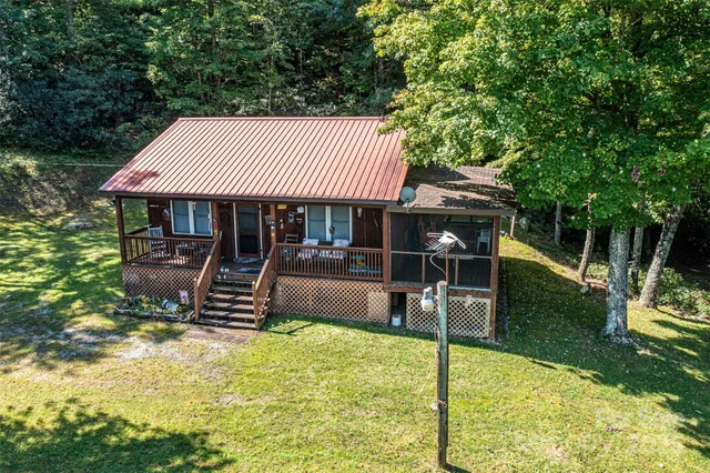 a view of a lush green field with mountains in the background