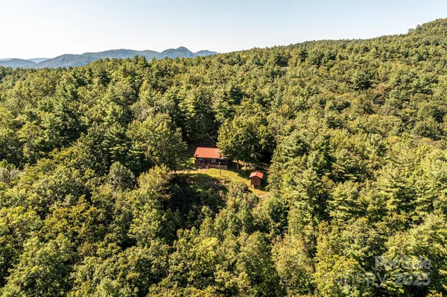a view of house with yard and sitting area