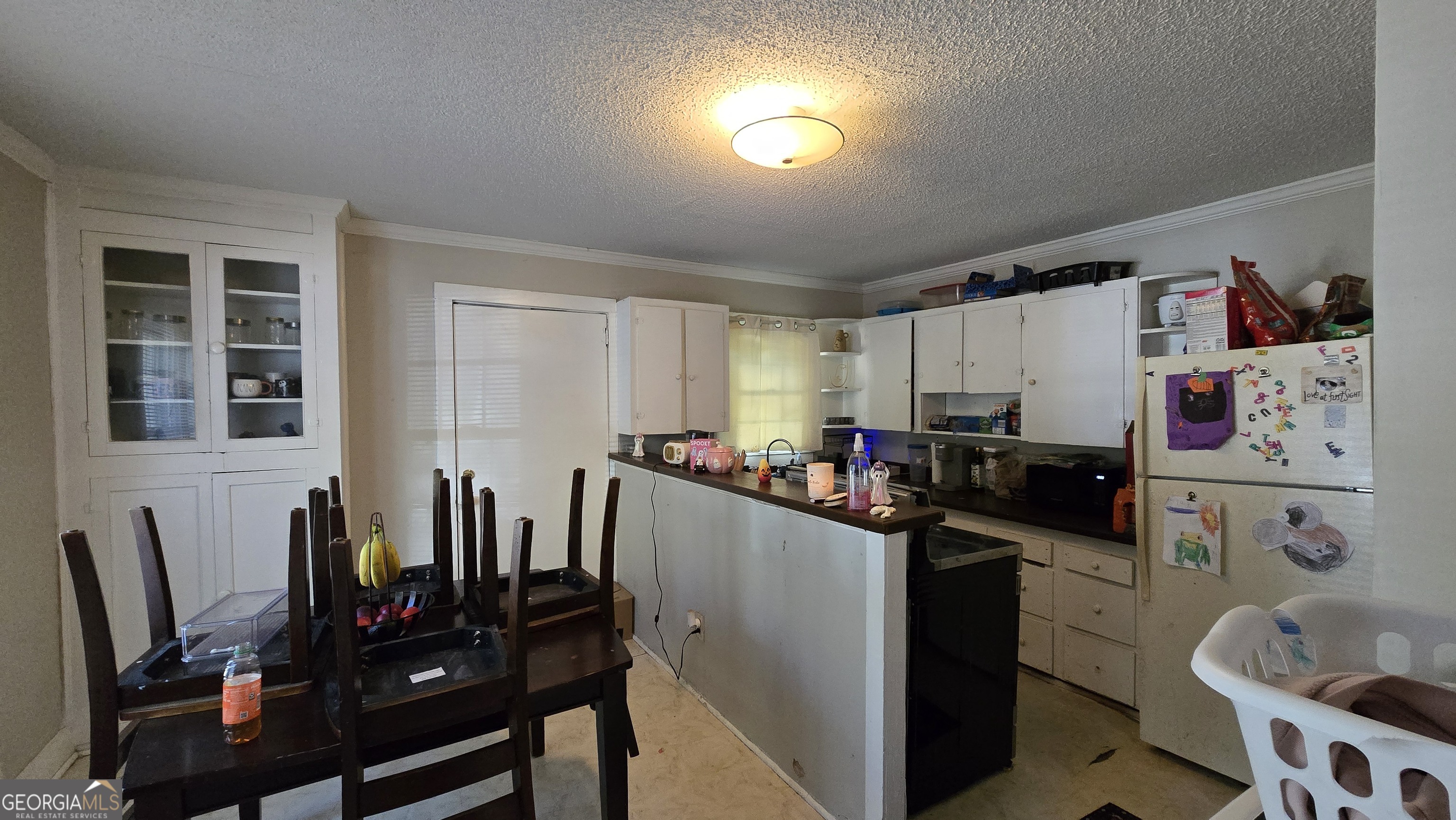 377 Dock Hyde Road Carrollton, GA 30116 - Photo 21 of 32 a kitchen with cabinets a sink and a stove next to a window