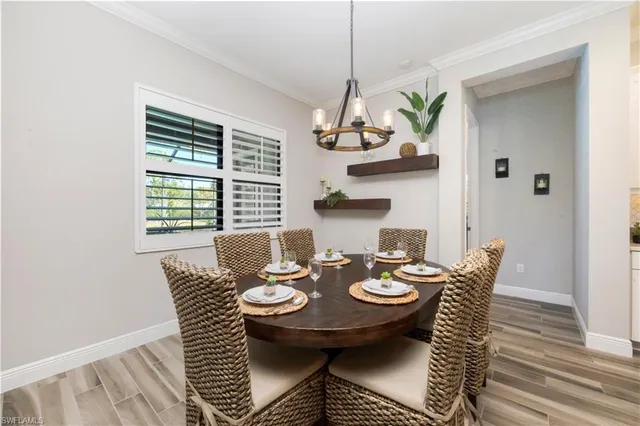 a view of a dining room with furniture wooden floor and chandelier
