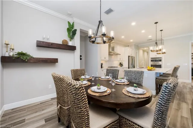 a dining room with furniture and wooden floor