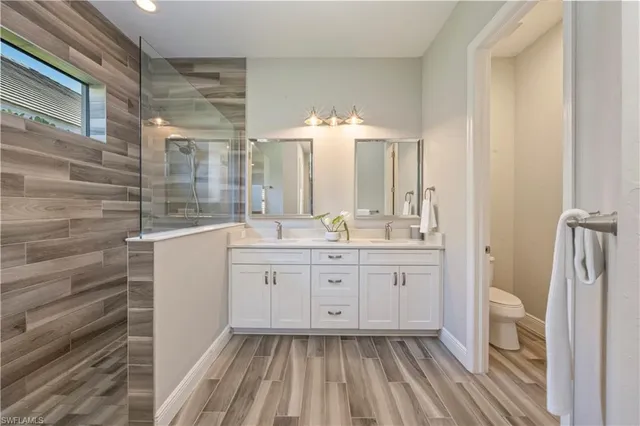 a bathroom with a double vanity sink and mirror