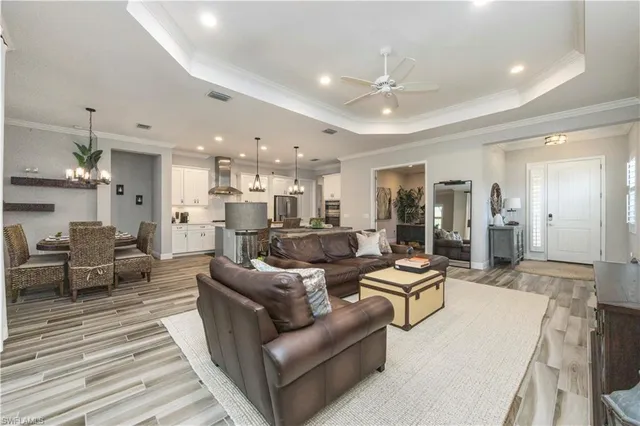 a living room with furniture and a view of kitchen