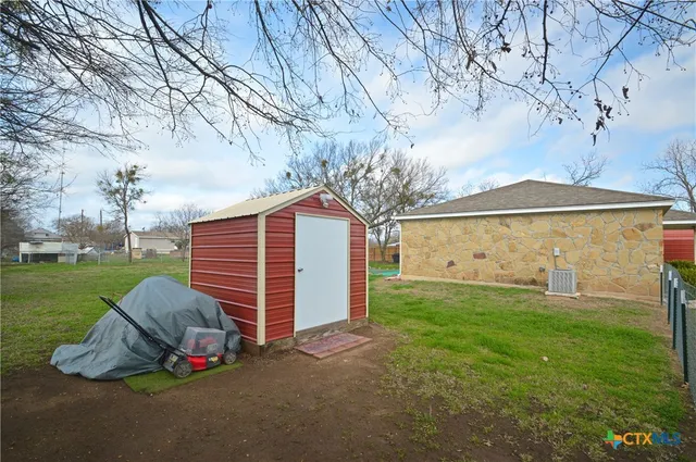 a view of a backyard with a small cabin