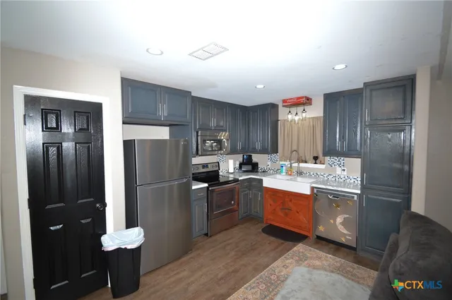a kitchen with a refrigerator and a sink