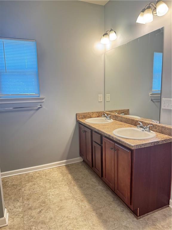 183 Spring Way Square Canton, GA 30114 - Photo 18 of 29 a bathroom with a sink and a mirror