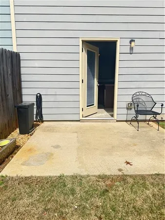 a view of a backyard with a chair and the iron stairs