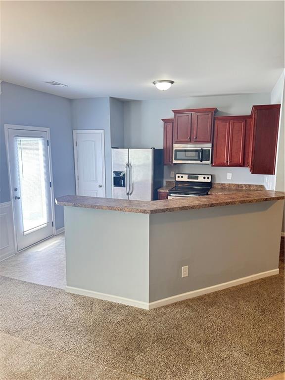 183 Spring Way Square Canton, GA 30114 - Photo 5 of 29 a kitchen with kitchen island granite countertop a stove top oven a sink a counter space and cabinets