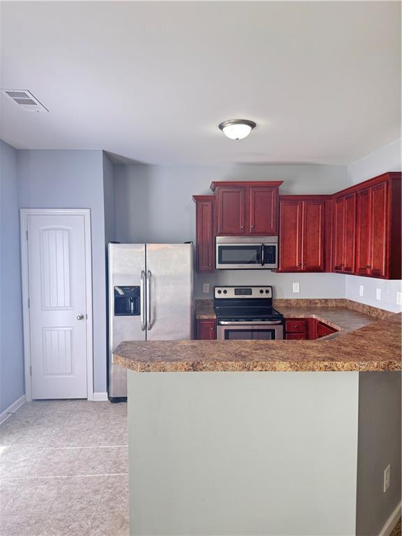 183 Spring Way Square Canton, GA 30114 - Photo 8 of 29 a kitchen with stainless steel appliances granite countertop a refrigerator sink and stove