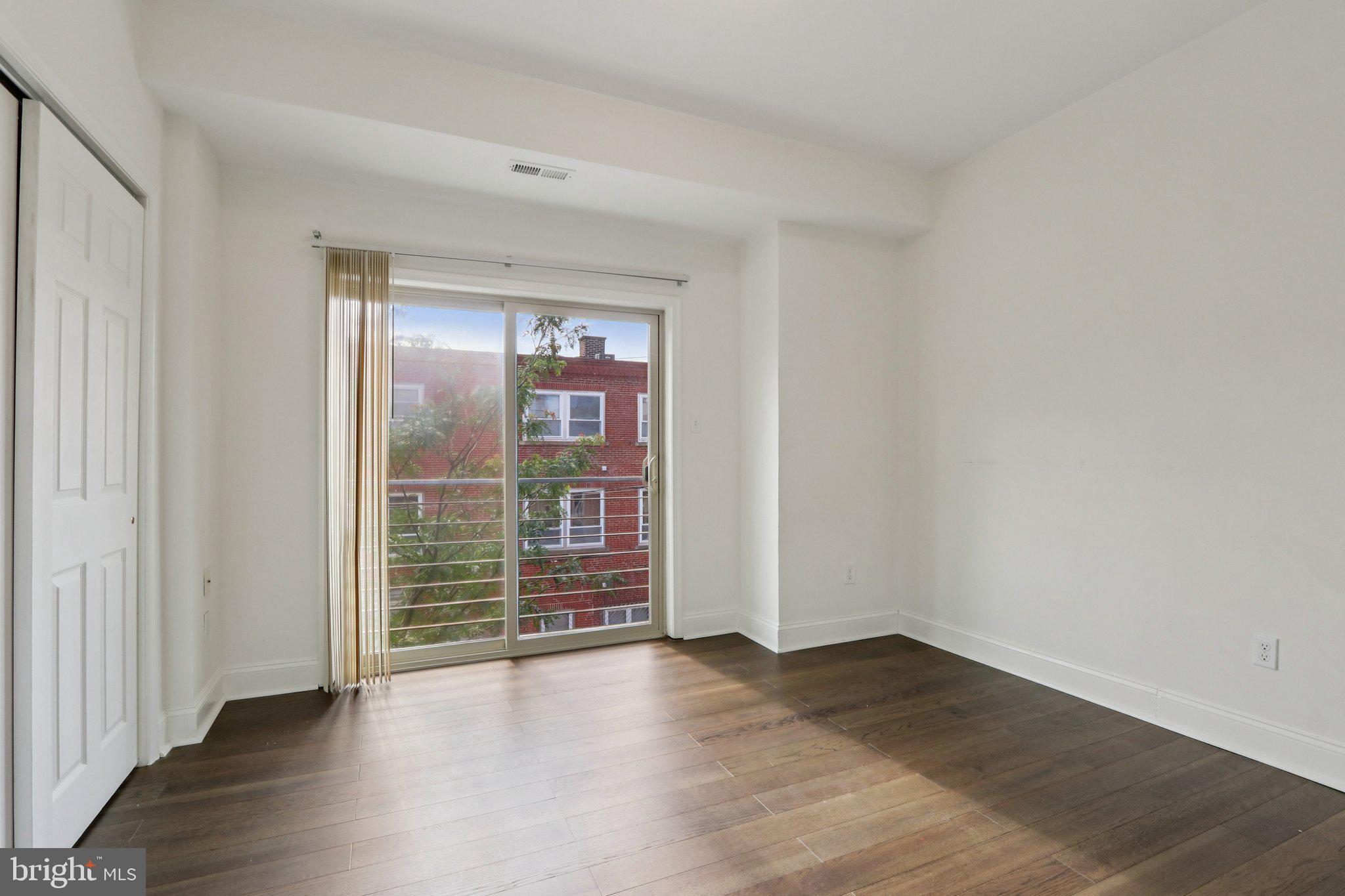 605 North 12th Street, Unit B Philadelphia, PA 19123 - Photo 13 of 22 an empty room with wooden floor and windows