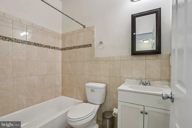 a bathroom with a toilet sink and shower