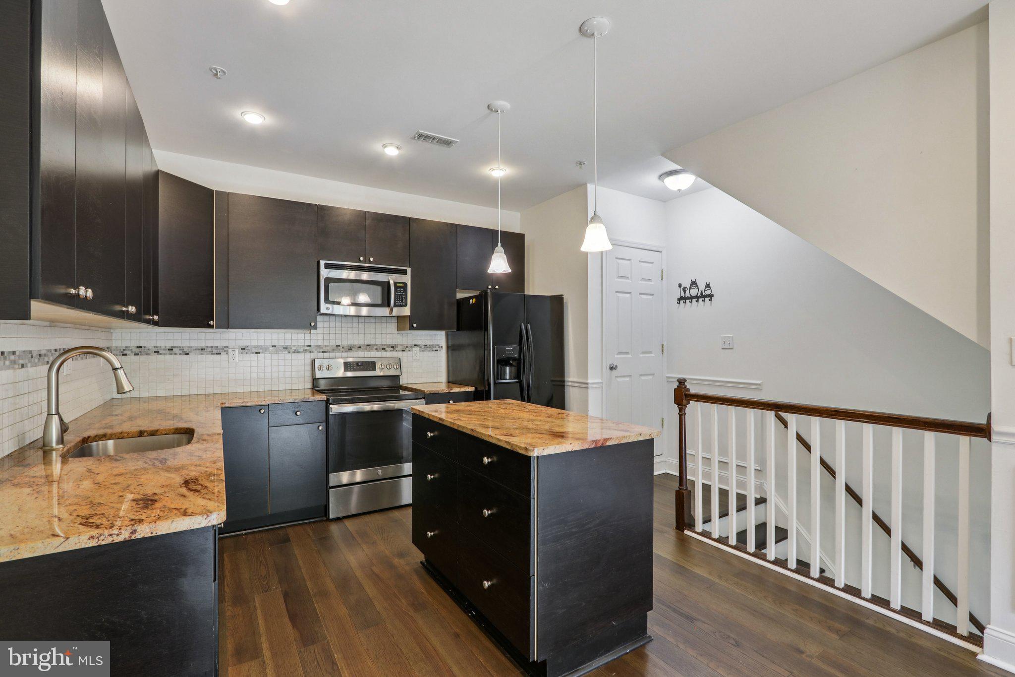 605 North 12th Street, Unit B Philadelphia, PA 19123 - Photo 4 of 22 a kitchen with stainless steel appliances granite countertop wooden cabinets and sink