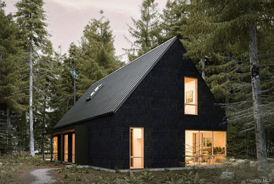 a front view of a house with large trees