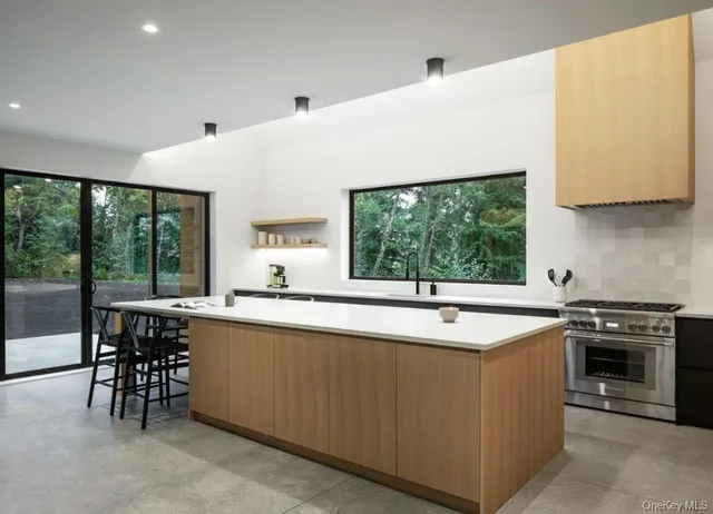 a kitchen with a sink and large window