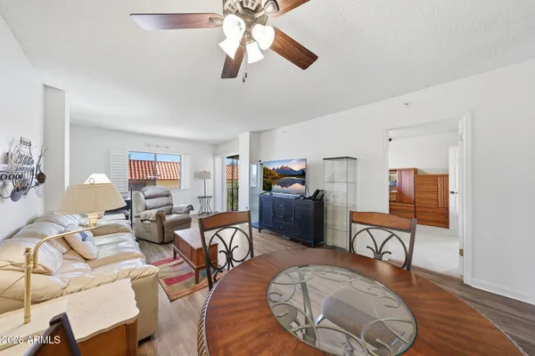 a living room with furniture a rug and a chandelier