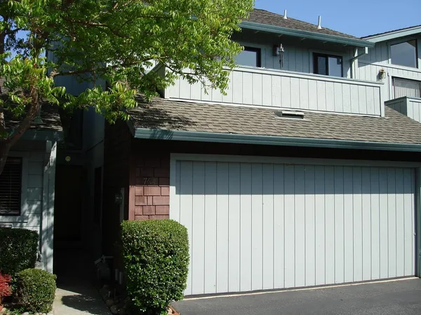 a view of house with a tree