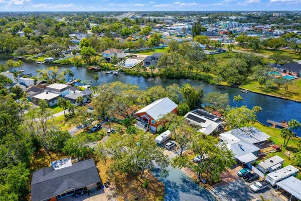 an aerial view of residential houses with outdoor space and lake view