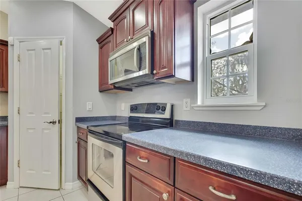 a kitchen with stainless steel appliances granite countertop a sink and cabinets with wooden floor
