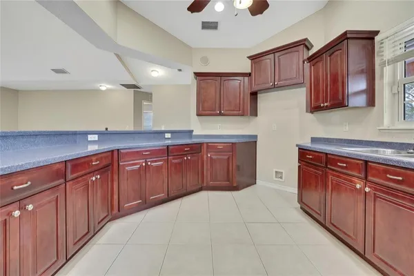 a spacious bedroom with a bed a dresser and large window