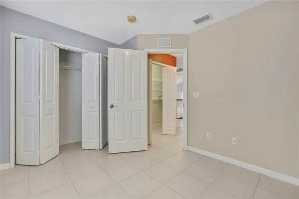 a living room with patio furniture and a potted plants