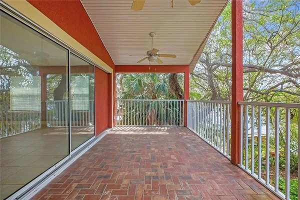 a view of a chairs and table in patio with wooden floor