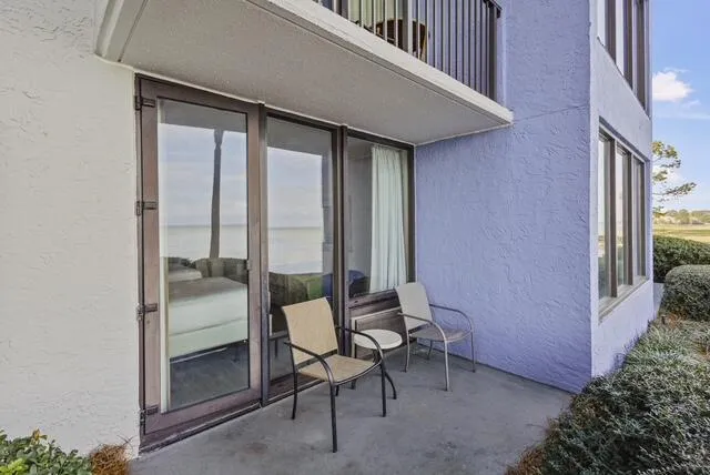 a balcony with chairs and with table