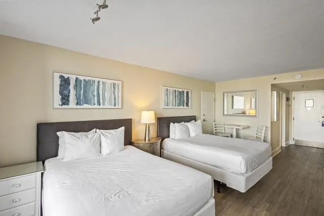 a bedroom with two beds and a night stand