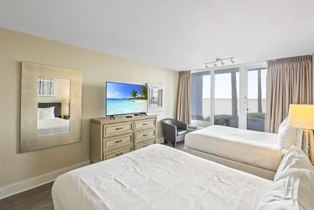 a bedroom with a bed and a flat screen tv