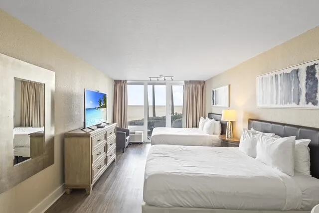 a spacious bedroom with a large bed and a large window