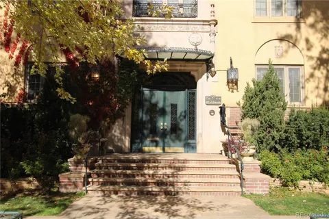 a view of a brick house with many windows