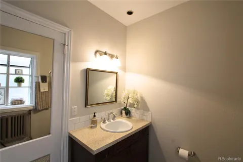 a bathroom with a sink vanity and mirror