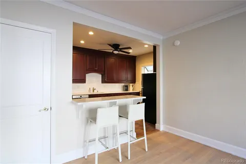 a kitchen with a sink cabinets and wooden floor